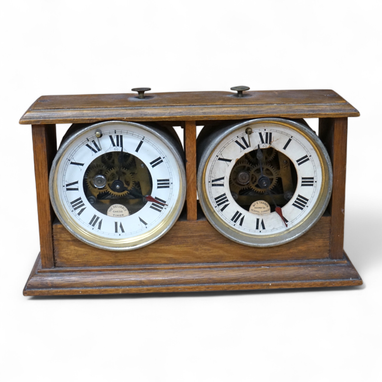 A William Tanner 'The Reliable Chess Timer' in an oak case, stamped to the reverse ‘HAO Make, Made in Wurttemberg’, (a.f.). Condition - poor, some damage and glass missing to one side.